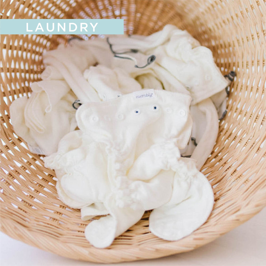 wicker basket with Esembly cloth diaper inners and cotton reusable wipes