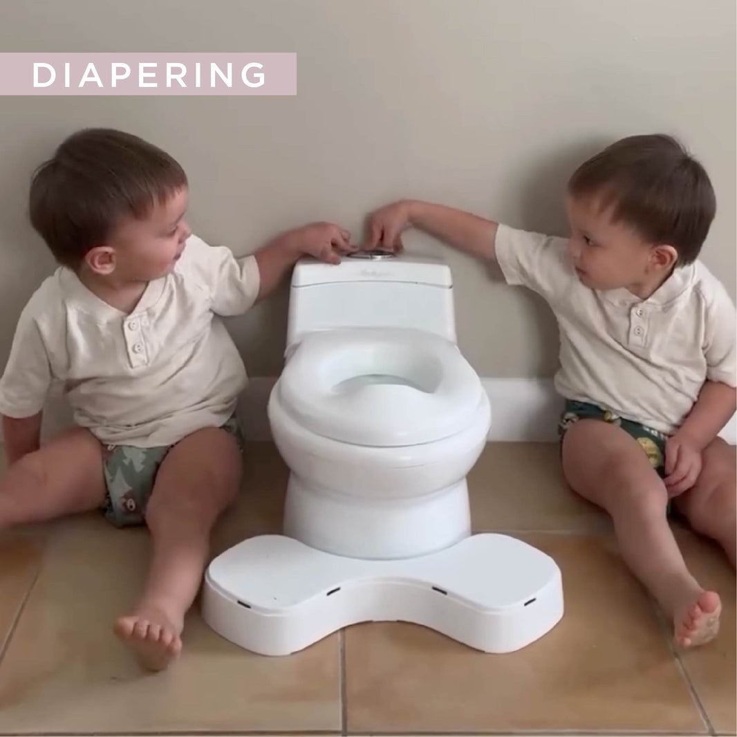 a little girl in a cloth diaper walking in a house