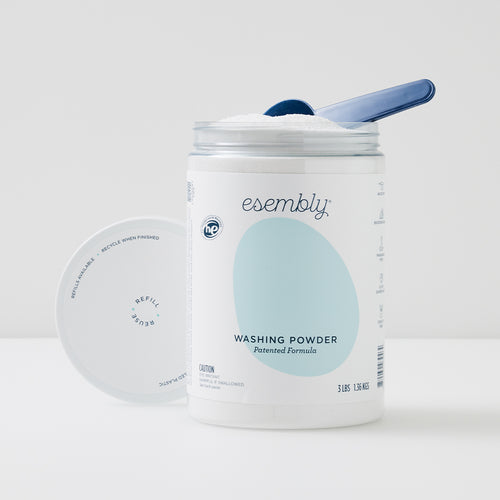 Esembly washing powder in a 3-pound reusable canister with scoop.