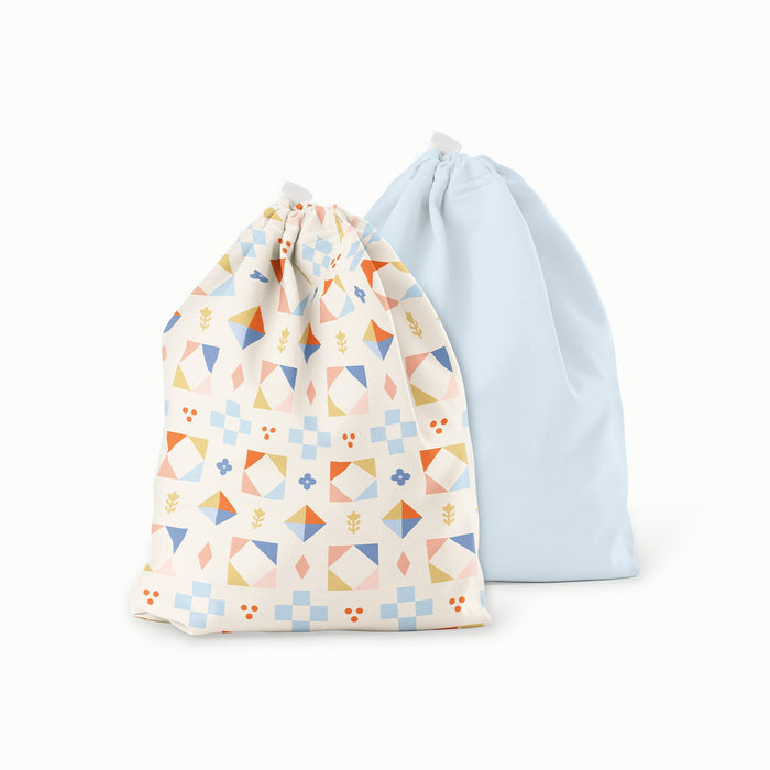 Two drawstring bags, one with a geometric pattern and the other plain light blue, on a white background.