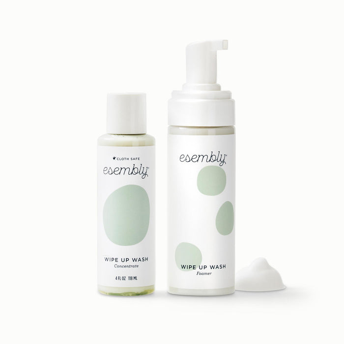 Front View of Esembly's 4oz Wipe Up Wash Concentrate and Wipe Up Wash Foamer next to a pile of foam