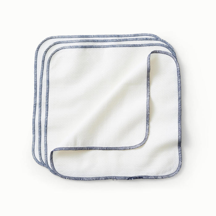 Flat lay of Esembly Wipe Ups which are white and have ink stitched edges