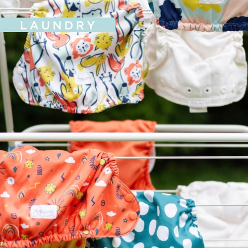 Colorful patterned outer clothes diapers on a drying rack