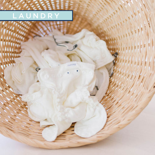 wicker basket with Esembly cloth diaper inners and cotton reusable wipes