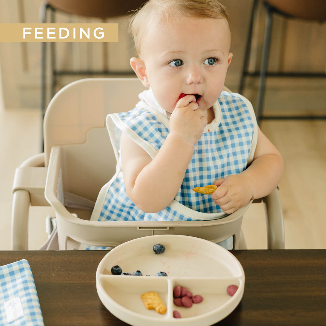 Baby eating in an Esembly bib
