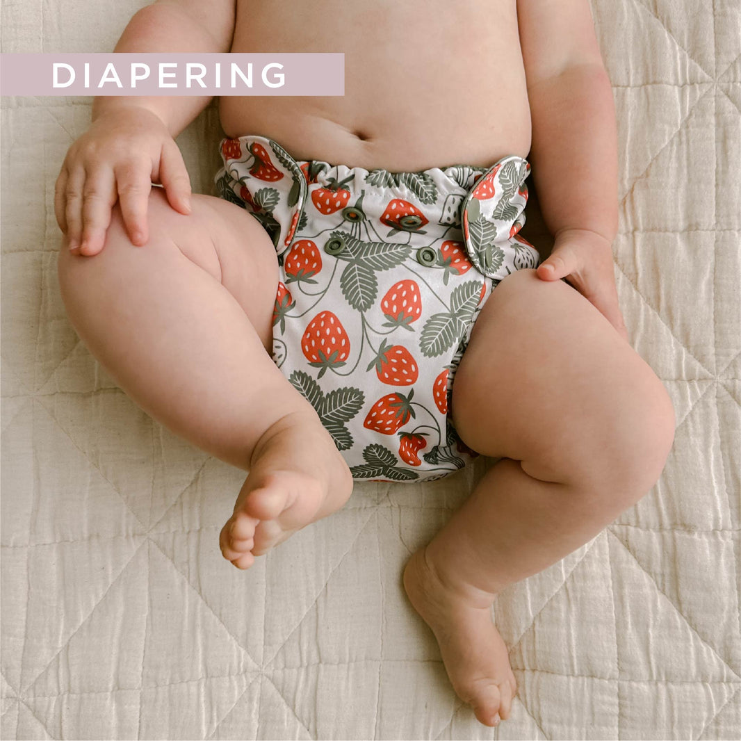 Baby in strawberry cloth diaper