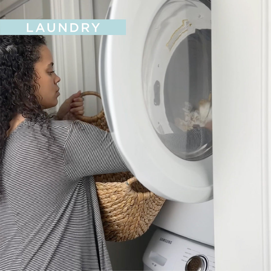 Women reaching into dryer and pulling out cloth diaper laundry