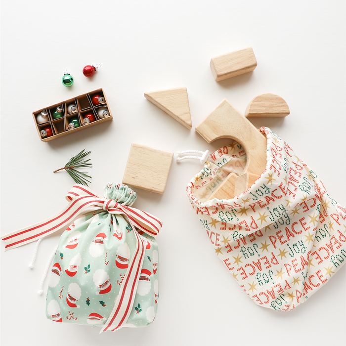 Ditty Bags in Peace + Joy and Santas used as gift wrap for kid's toys