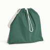 Back view of Esembly Day Bag with a cream flap, dark green back, and mid-tone green with an outlined check pattern