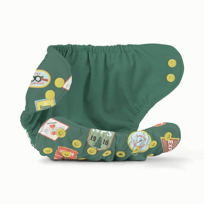 Open view of Esembly Outer in Adventure Badges (a dark green background with camping and outdoorsy themed badge illustrations)