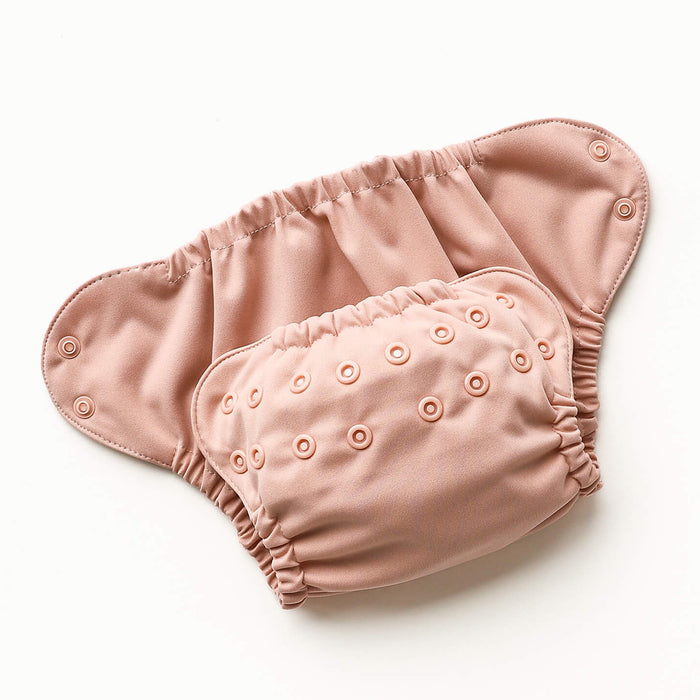 Open view of Esembly Outer in a light pink color with a mid-tone yellow interior