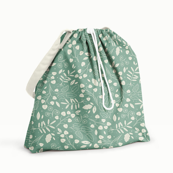 Back View of Botany Day Bag. Front and back is Botany (green background with white leaves) and flap and strap is Parchment (soft white)