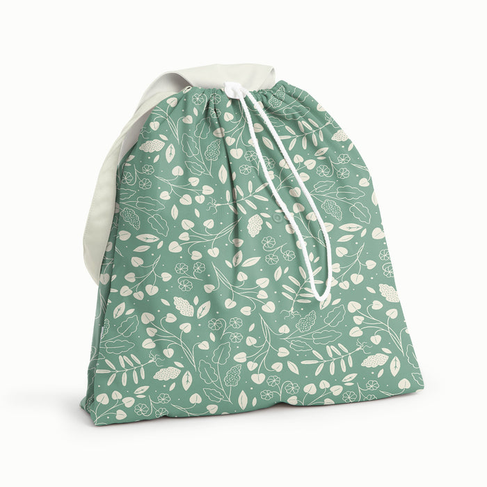 Front View of Botany Day Bag. Front and back is Botany (green background with white leaves) and flap and strap is Parchment (soft white)