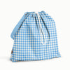 Back view of an Esembly Day Bag with a blue gingham back, Bunnies (bunnies, flowers, and ducks illustrated by Flora Waycott on a mid-tone blue background) front, and mid-tone blue strap