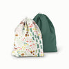A ditty bag duo in Fantastic Fungi (an off-white background with colorful mushroom, trees, and leaves illustrations) and Forest (a dark green solid)