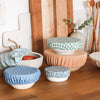 Set of ceramic bowls with bowl covers from the floursack collection on a wooden surface