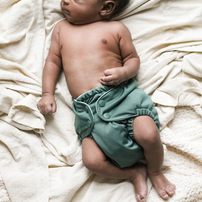 New born baby wearing an Outer with a deep dark green color