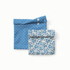 Two fabric pouches with blue and white polka dot pattern and blue floral pattern on a white background
