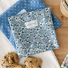 Floral-patterned and blue with white polka dot Snack + Sammy pouches with cookies.