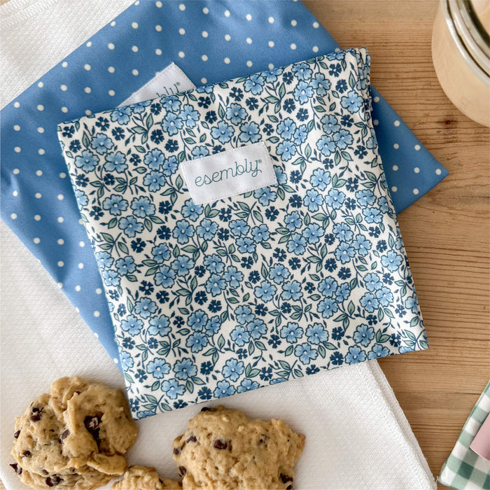 Floral-patterned and blue with white polka dot Snack + Sammy pouches with cookies.
