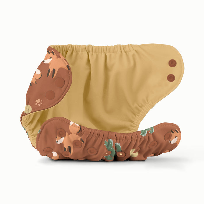 Cloth diaper with a brown background and fox pattern and a yellow interior