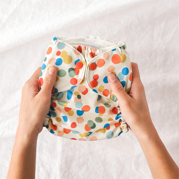 Person holding an Esembly Outer in Funfetti