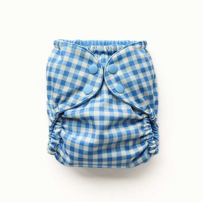 Front View of an Esembly Outer in blue Gingham with a solid blue interior