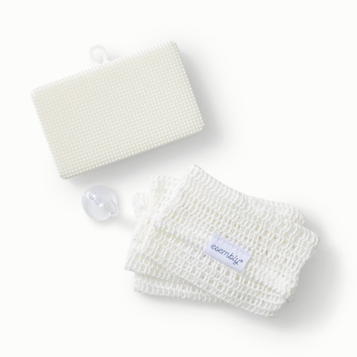 A GoTwo sponge with next to a pile of three GoTwo Sudsers and a see-through hook