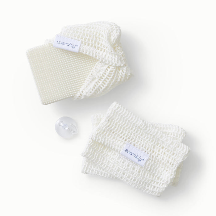 GoTwo silicone sponge partially inside a GoTwo Sudser and next to a pile of two GoTwo Sudsers and a clear hook