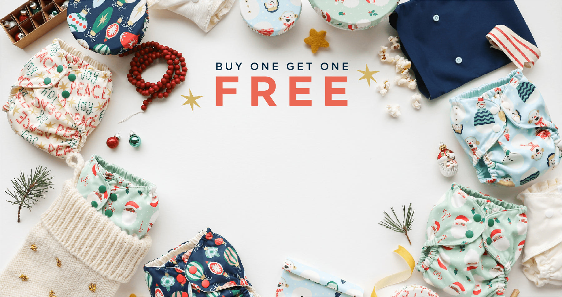Baby cloth diapers with festive patterns on a white background, featuring 'Buy One Get One Free' text.