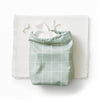 A stack of paperless towels with a ditty bag in Lattice (a light green background with white lined grid pattern) with paperless towels coming out the top and a white hook