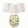 Three white cloth Inner diapers with a lemon-patterned Outer diaper on a white background