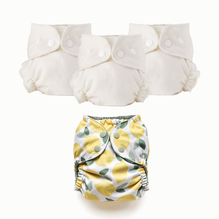 Three white cloth Inner diapers with a lemon-patterned Outer diaper on a white background