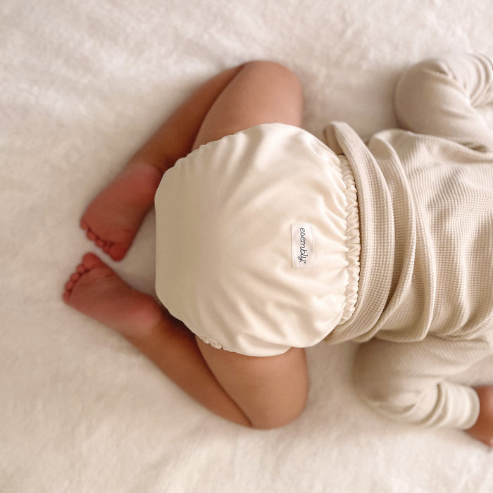Baby wearing an Outer with an off-white cream color
