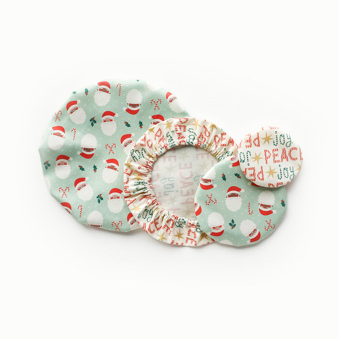 Esembly Bowl Caps in Santas (a mint green Outer with illustrated Santa heads, mistletoe, and candy canes) and Peace + Joy (a white background with red peace and green joy words)