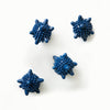 A set of four blue laundry ball agitators arranged on a white surface.