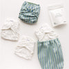 A Try it Kit in Sunday Stripe — blue, green, and white stripes — with Inners and Washing Powder