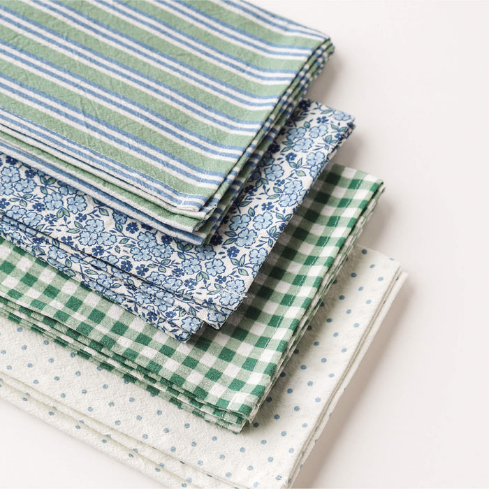 Stack of tea towels with various patterns on a white background