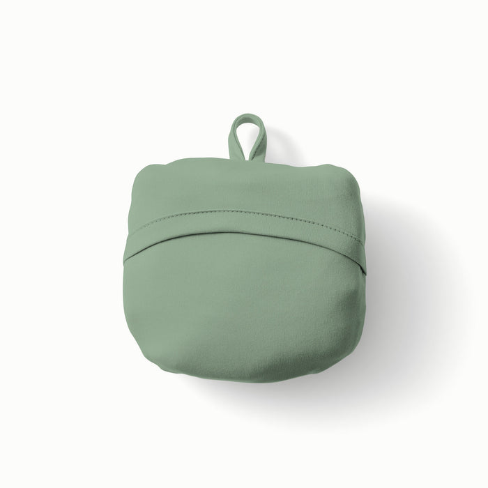 Rolled Up View of Esembly Carryall Bag in Theory colorway with a mid-tone green exterior, green flap, and loop at the top