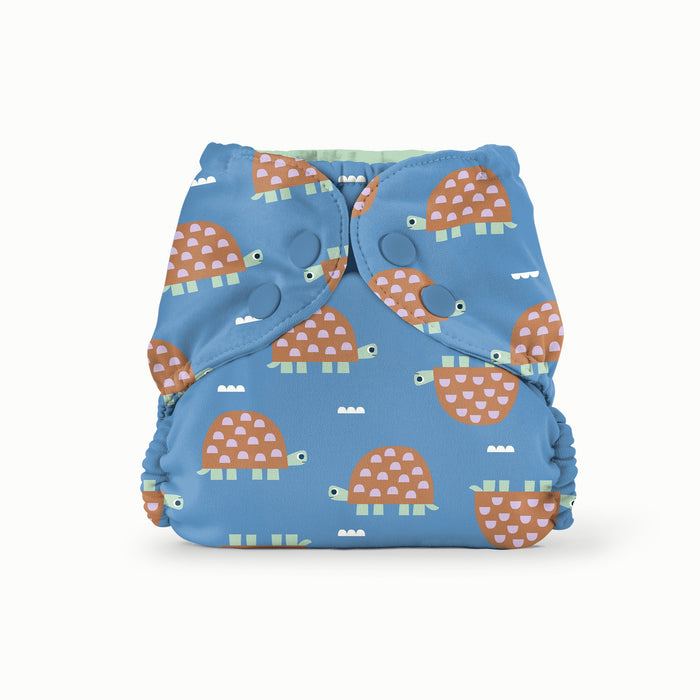 Blue cloth diaper with turtle pattern on a white background
