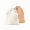 Two drawstring bags, one with a brown grid pattern on a white background and the other solid brown.