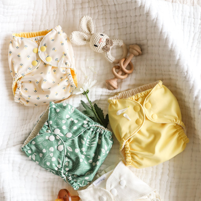 Flatly with Esembly Outers in Buds (a parchment background with tiny yellow and green flowers), Buttercup (a buttery yellow solid color), and Botany (green background with white leaves)