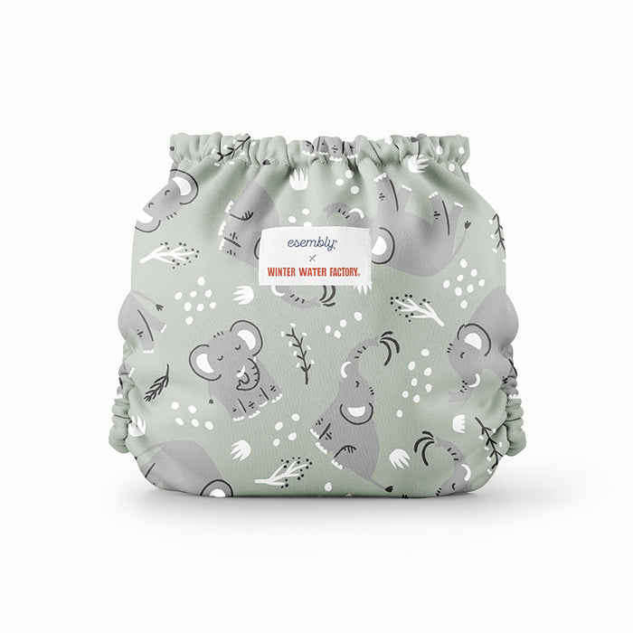 Back view of Esembly Outer in a light green background with light grey elephants and white and black tree limbs and white sporadic polkadots 