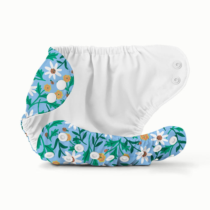 Open view of Esembly Outer with a light blue background with white and yellow flowers with light green and dark green leaves and a white interior