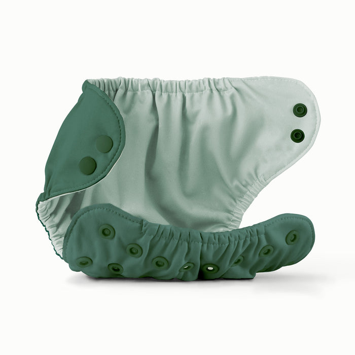 Open view of Esembly Outer in a deep dark green color with an interior with a light mint green color