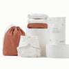 Waterproof Ditty Bag and Outer in Clay (a mid-tone reddish brown), 3 White Cotton Inners, and a sample size bag of Washing Powder